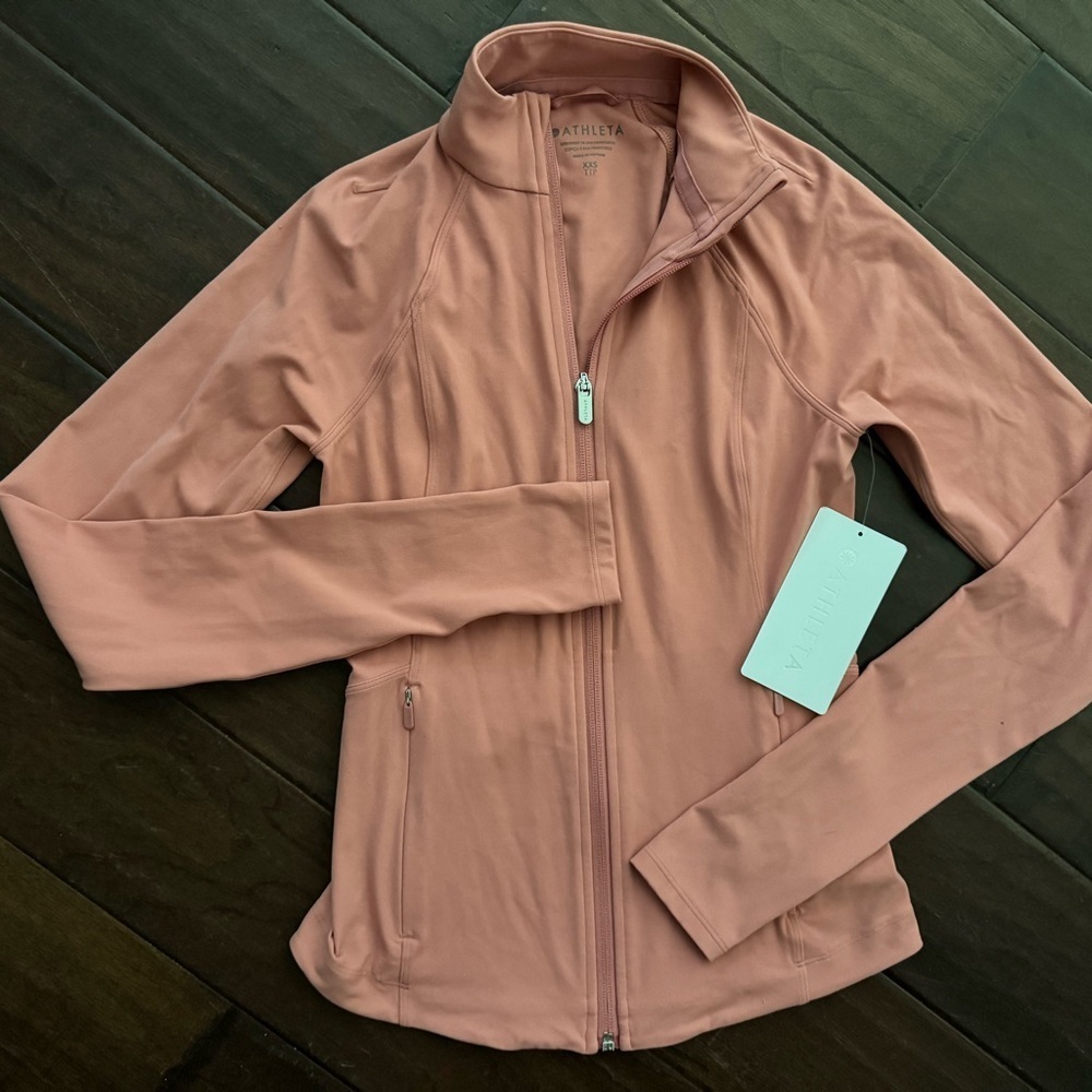 Athleta Salutation zip-up jacket in salmon or coral color. Size XXS. NWT.